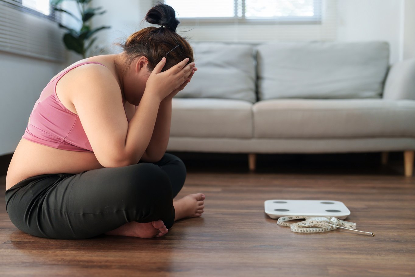 Stressful Asian  woman sad of dieting Weight loss fail